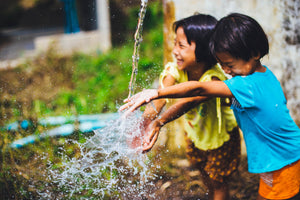 School children playing in fresh clean water